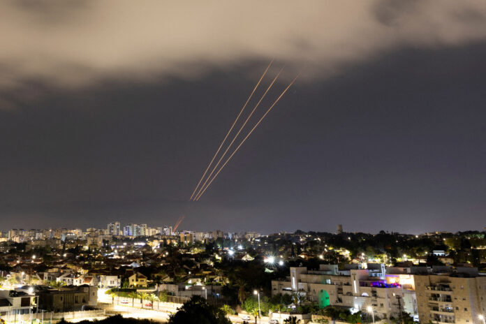 FILE PHOTO: An anti-missile system operates after Iran launched drones and missiles towards Israel, as seen from Ashkelon